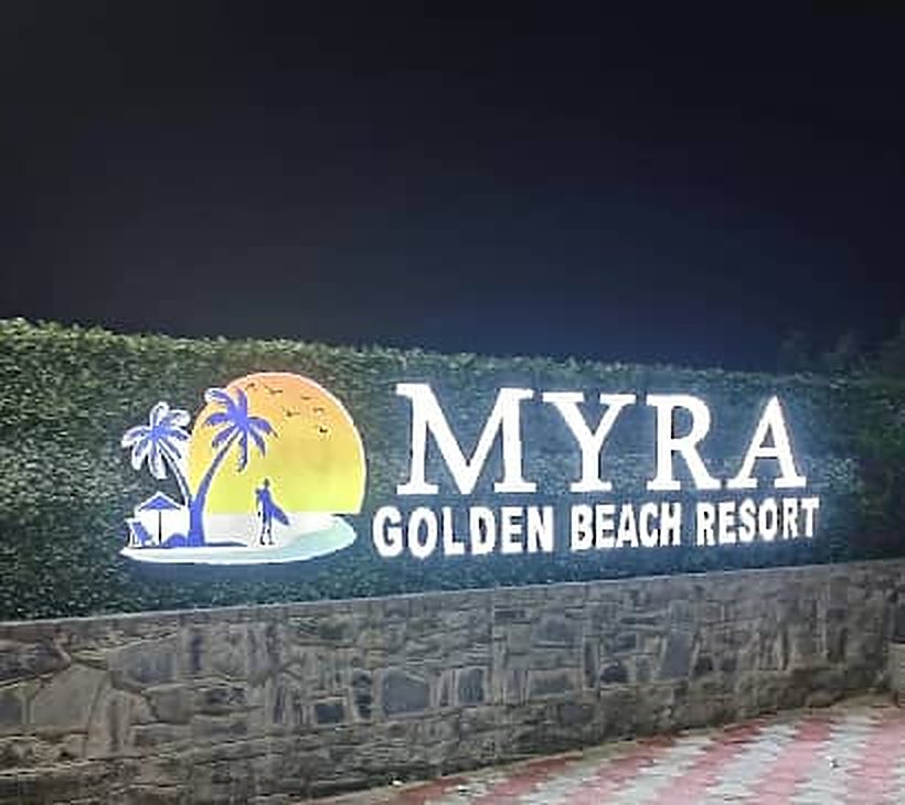 Resort sign lit up at night in Chirala