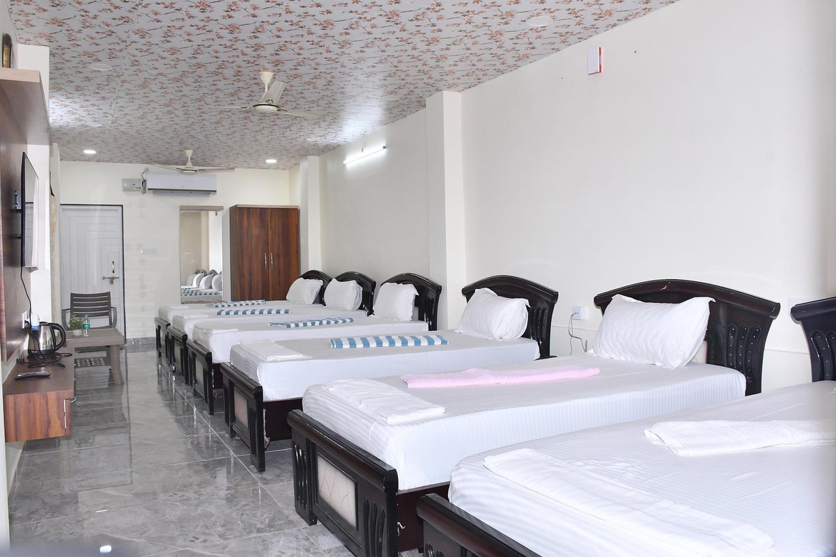 Family bedded hall with several beds at Myra Golden Beach Resort, Chirala